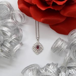 14K white gold diamond necklace with filigree detail and oval ruby in center