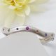 Wave sterling silver hinged bangle with flush set fancy colored sapphires