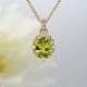 Vintage inspired halo necklace in 14k yellow gold with oval peridot gemstone.