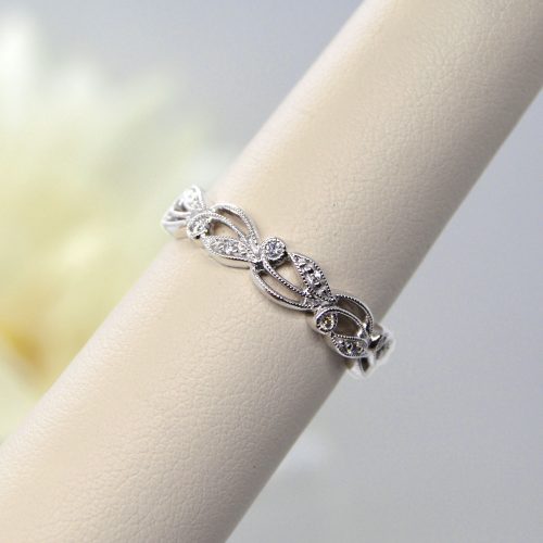 Stackable ring in 14K white gold with accent diamonds in a millgrain filigree setting