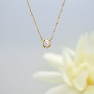 14K yellow gold dainty necklace with round white pearl and accent diamonds on chain