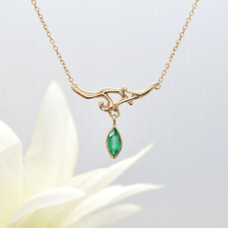 custom emerald marquise lariat style dainty art nouveau inspired necklace with scrolling branch design necklace in 14k yellow gold