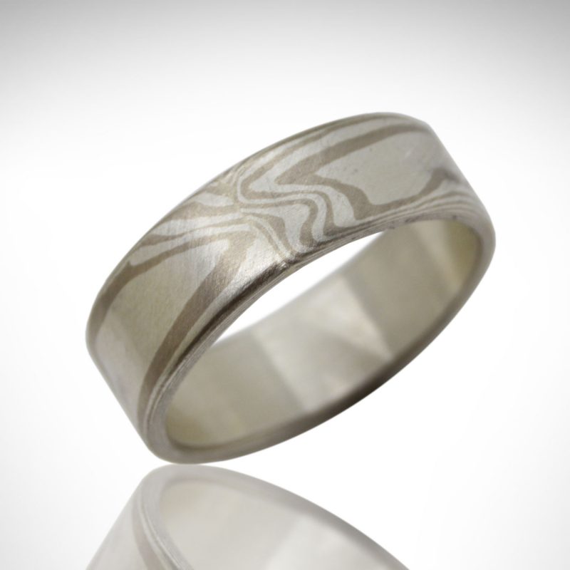 Mokume gane wedding band in 14k palladium white gold and sterling silver in a wood grain pattern, designed by Morgan's Treasure