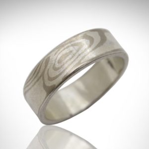 Mokume gane wedding band in 14k palladium white gold and sterling silver in a wood grain pattern, designed by Morgan's Treasure