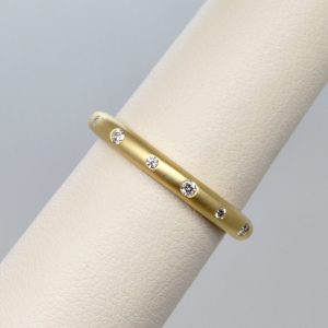 Brush matte satin finish yellow gold wedding band or stackable ringrounded with flush set accent diamonds