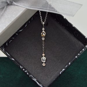 Natural raw diamonds in lariat style pendant with matching chain. 14K white gold with full-cut diamond accents. Designed by Morgan's Treasure in Westerville, OH