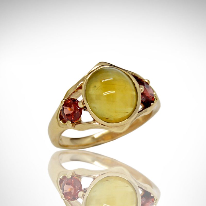 Cat's eye chrysoberyl cabochon oval gemstone with dark red orange spessartite garnets in 14K yellow gold ring, designed by Morgan's Treasure in Westerville, Ohio
