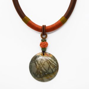 Necklace with green and orange agate medallion, silk knot and wrapped cord