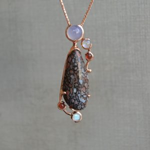 Dinosaur bone gemstone pendant in rose gold with chalcedony, garnets, rainbow moonstones, custom designed by Morgan's Treasure