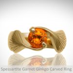 round Spessartite orange garnet gemtone ring with bypass prong design and carved ginkgo leaves in yellow gold, custom made Morgan's Treasure