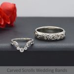 Ladies shadow wedding band in platinum with 3 stone millgrain bezel set diamonds and vintage inspired scroll carving. Matching men's wedding band with inset diamond and intricate fancy scroll carving