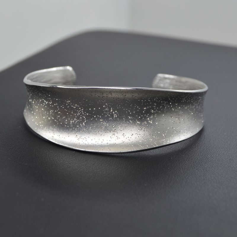 Sterling silver cuff bracelet with texture to create a sparkling effect.