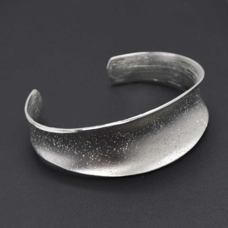 Sterling silver cuff bracelet with texture to create a sparkling effect.