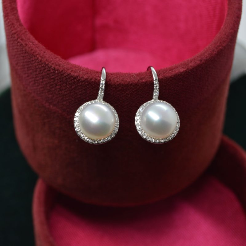 Round white pearl earrings with diamond halo on lever backs in 14K white gold