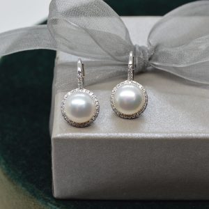 Round white pearl earrings with diamond halo on lever backs in 14K white gold