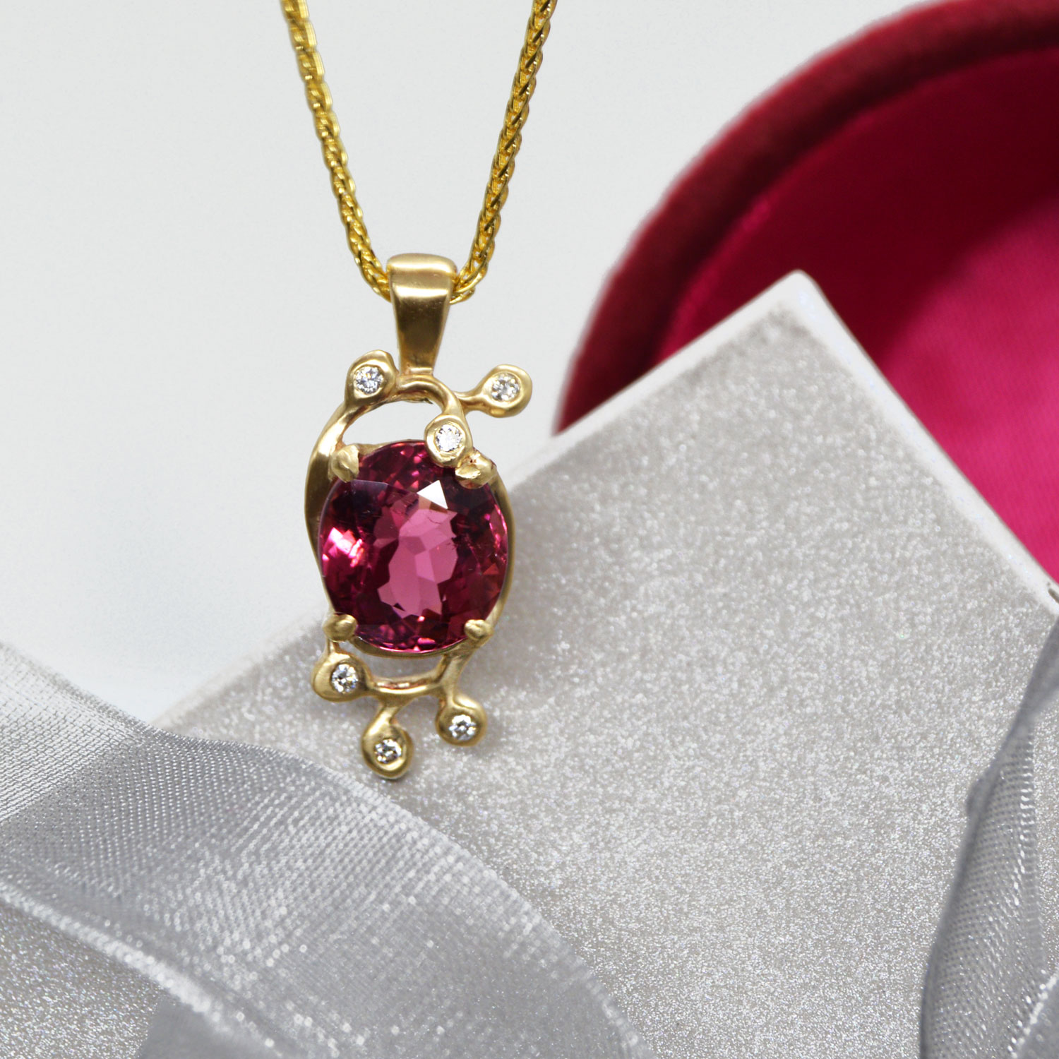 Red Tourmaline oval faceted gemstone in delicate leaf design with accent diamonds and a satin finish, designed by Morgan's Treasure