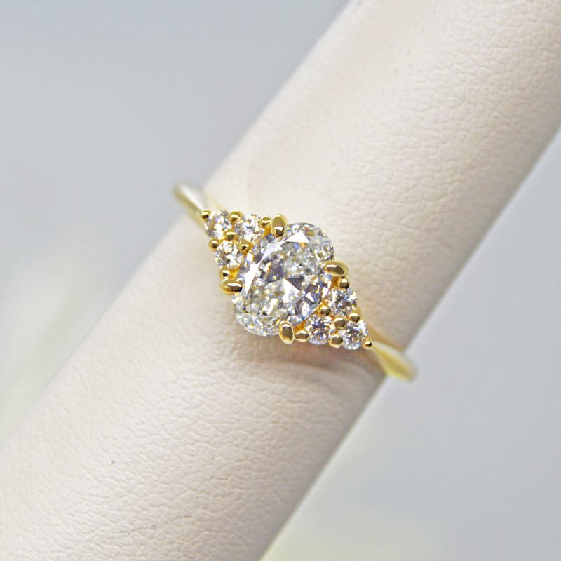14Kt yellow gold engagement ring featuring .90 CT oval cut diamond and .19 CTW accent diamonds.