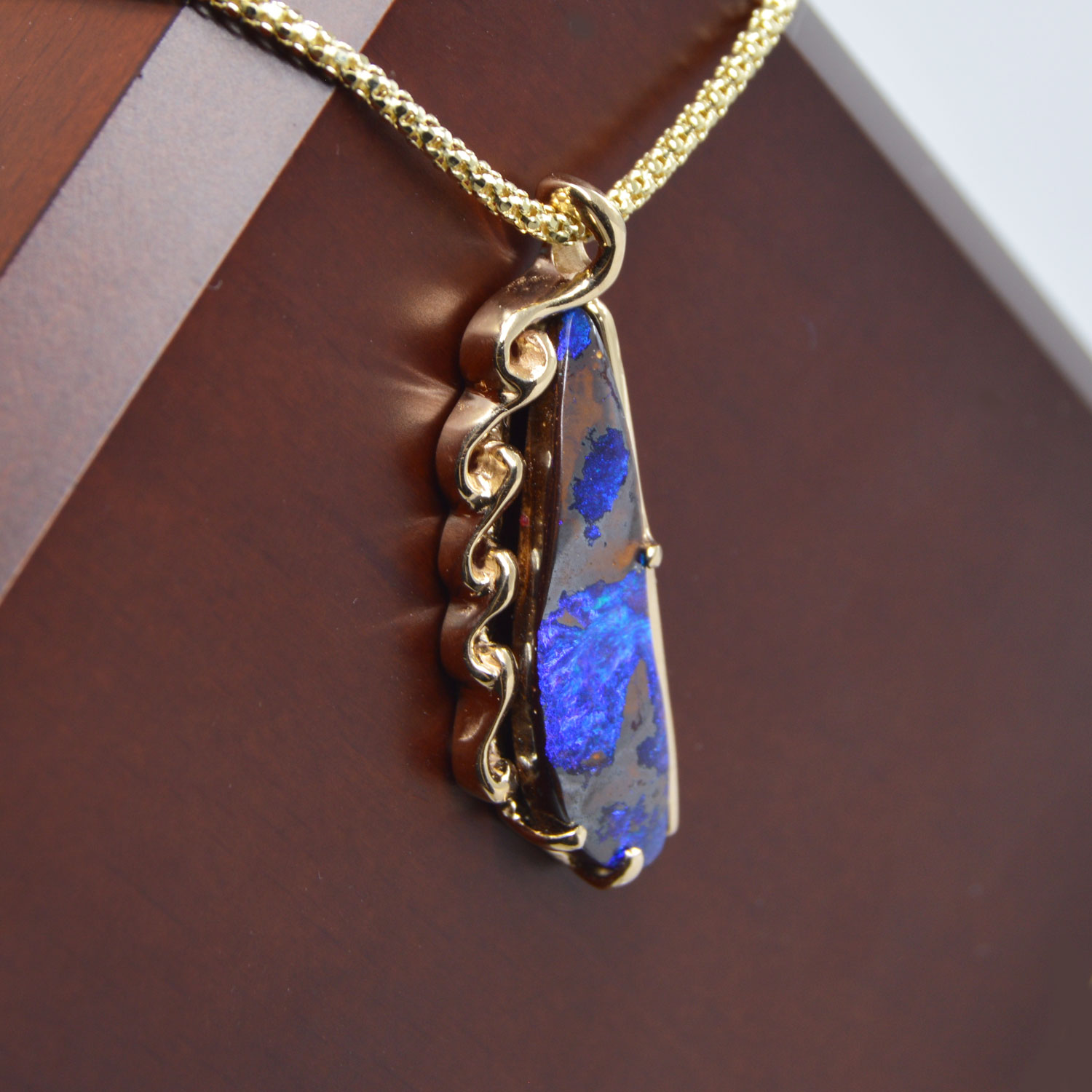 Australian boulder opal pendant custom jewelry with blue and brown gemstone and 14K yellow gold carved pendant made by Morgan's Treasure