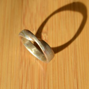 Mokume gane wedding band with mobius twist in 3-tone tricolor metals with 18k yellow gold, 14k rose gold, sterling silver. Handmade by Morgan's Treasure Custom Jewelry