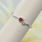 two-stone bezel set ring with garnet and diamond