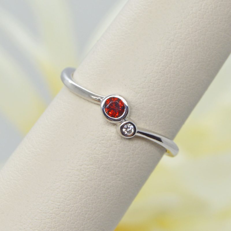 two-stone bezel set ring with garnet and diamond