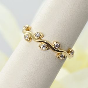 A vine of diamonds in 14K yellow gold stackable ring or wedding band