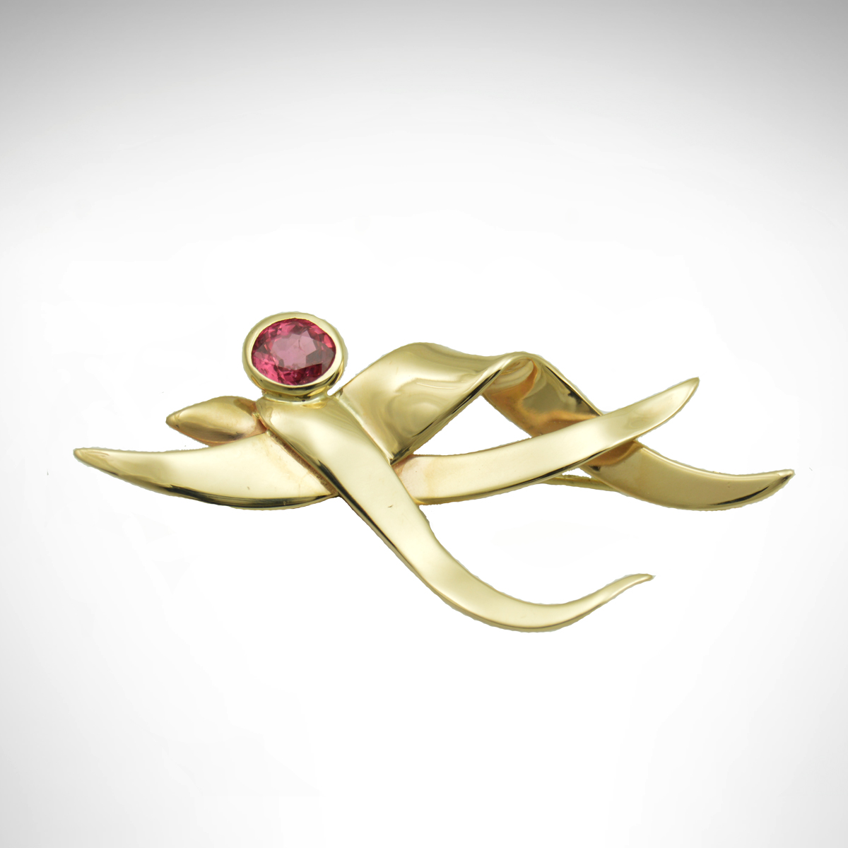 14k yellow gold brooch with dark pink oval sapphire in bezel, pin with wave-like design, custom design