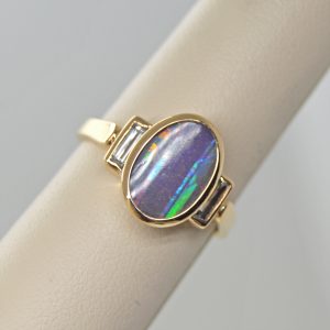 Australian Boulder Opal natural oval gemstone, bezel set oval three stone ring with baguette diamonds in 14k yellow gold ring. Designed by Morgan's Treasure in Westerville, OH
