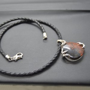 Dinosaur bone gemstone in sterling silver carved pendant on black braided leather cord, designed by Morgan's Treasure