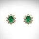 14K yellow gold earrings with oval emeralds and diamond halos.