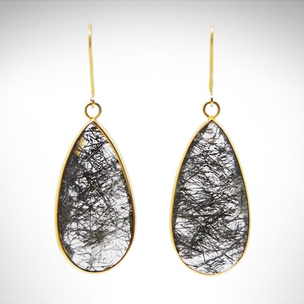 14k yellow bezel earrings dangle from lever-backs with faceted, translucent rutilated quartz gemstones in a teardrop shape.