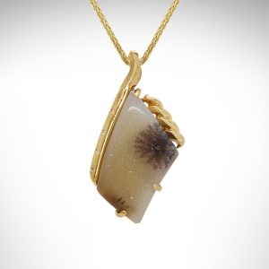 14K yellow necklace with dendritic druzy pendant, a natural agate gemstone with quartz crystals and dendrite inclusions in black and white with yellow gold design and accent diamonds flush set along side.