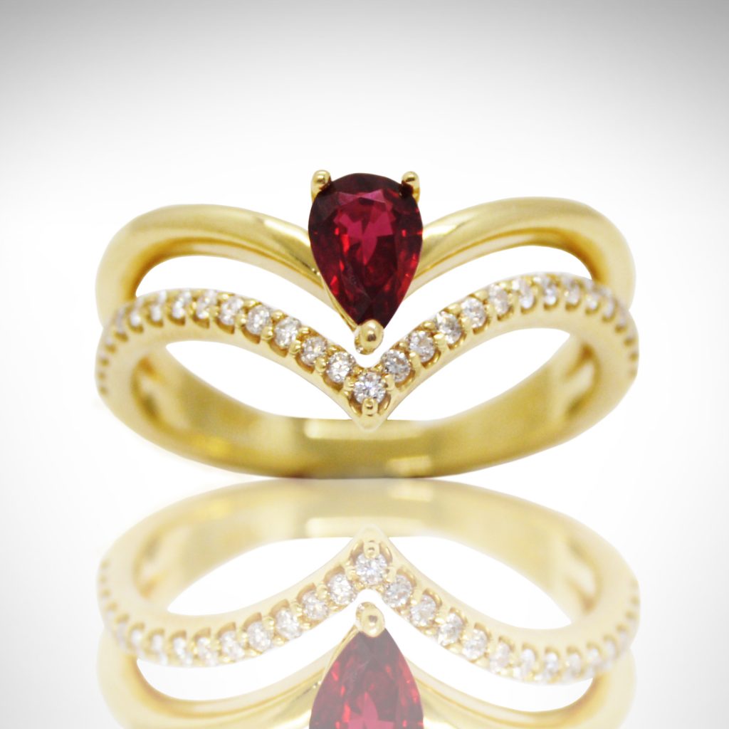 14k yellow ring with pave diamonds and pear cut ruby