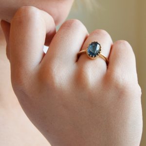 14ky gold ring with prong-set cabochon oval blue indicolite tourmaline gemstone.