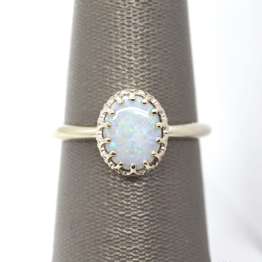 14K white gold ring with crown style prong setting and oval cabochon opal gemstone