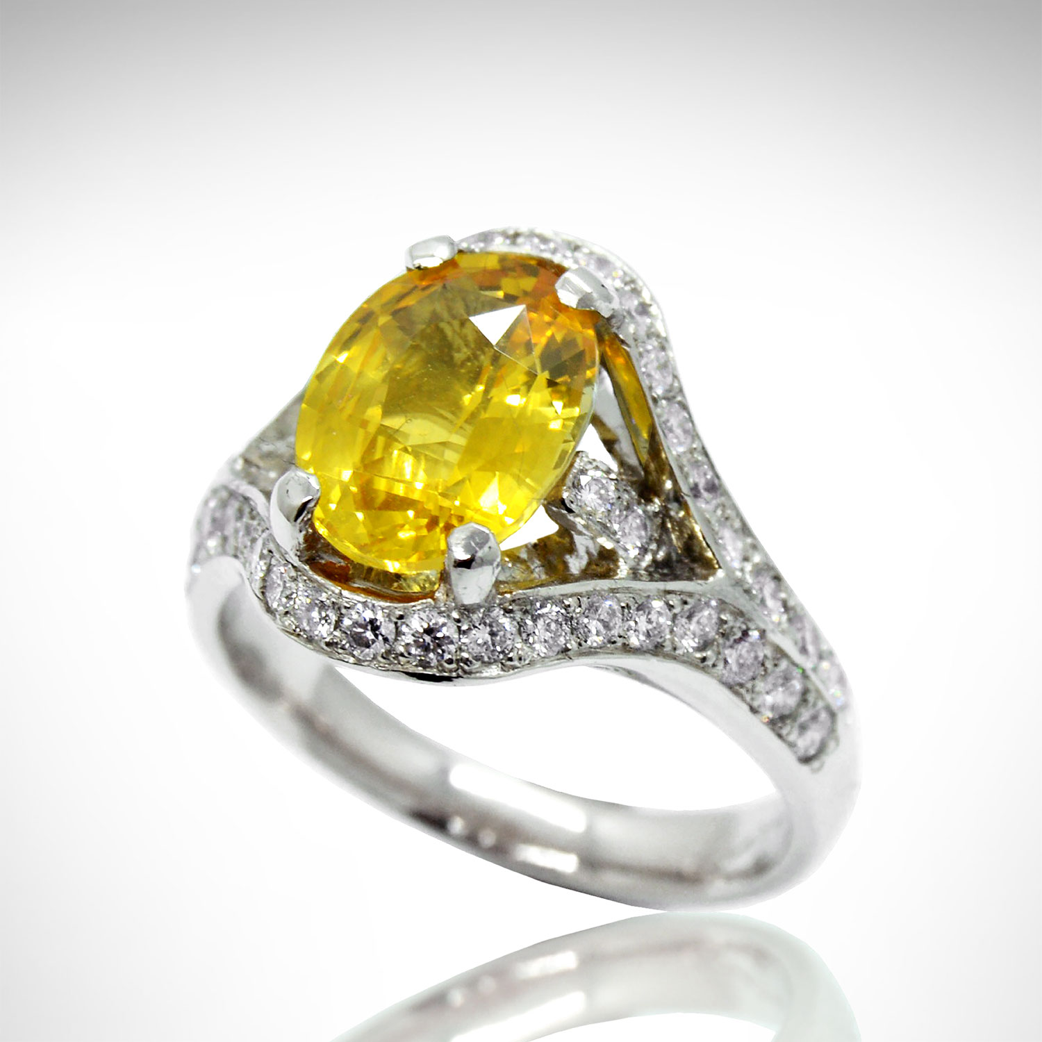 Oval yellow sapphire ring in white gold with pave set diamonds