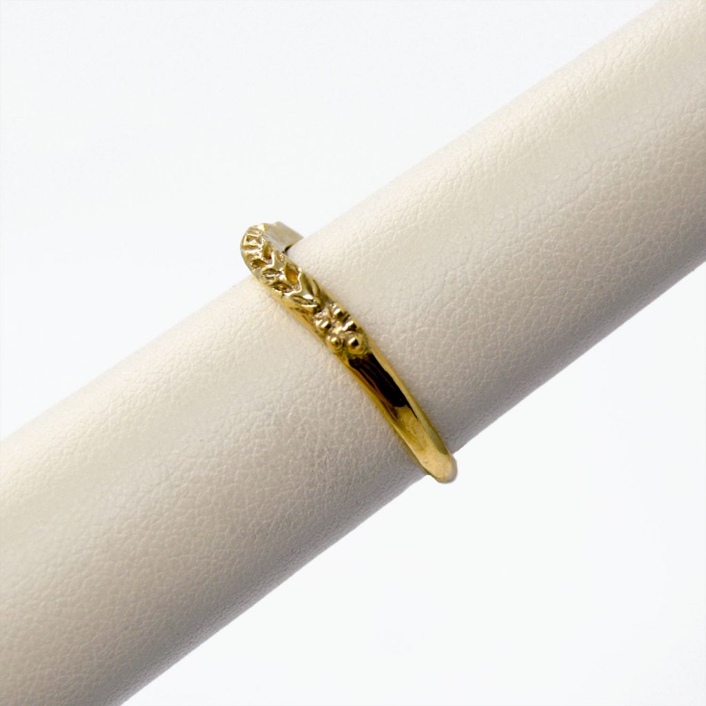 Carved 14KY gold band with curve to fit against engagement ring