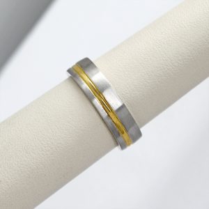 mens two-tone wedding band made with 14k white and yellow gold in an offset stripe pattern, a contemporary ring.