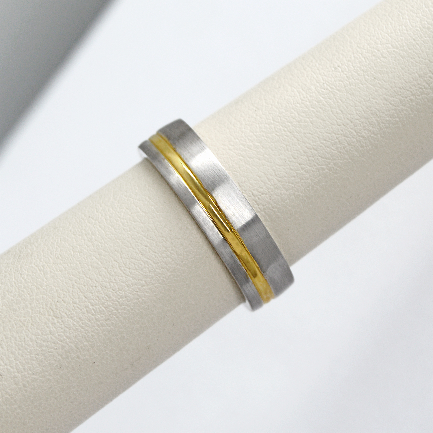 mens two-tone wedding band made with 14k white and yellow gold in an offset stripe pattern, a contemporary ring.