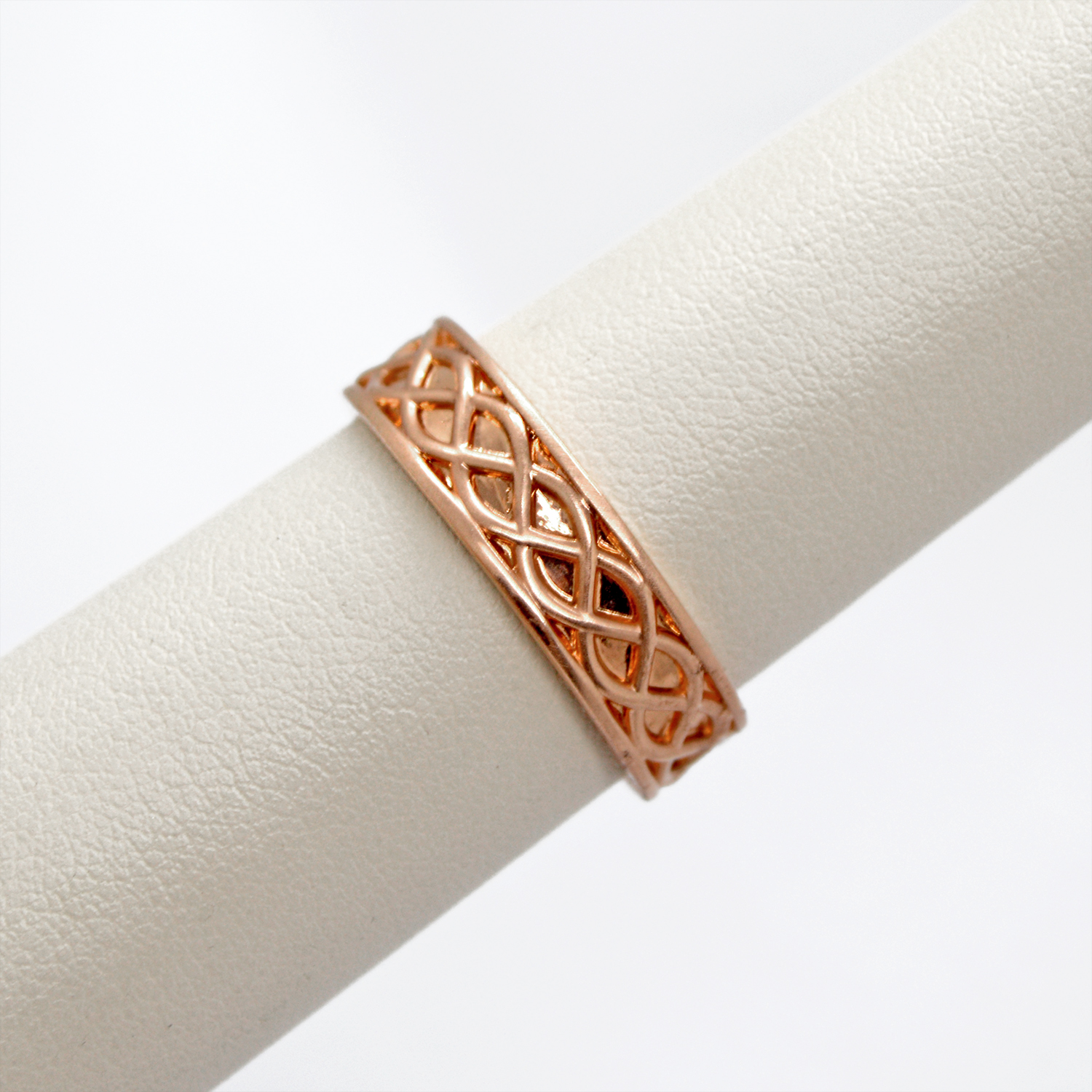Celtic inspired mens wedding band in 14k rose gold with a braided design
