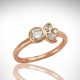 14k rose gold diamond ring with bezel-set round and marquise diamonds and simple band, minimalist design with floral/ leaf inspiration.
