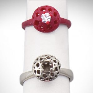 A wax model and finished white gold filigree engagement ring
