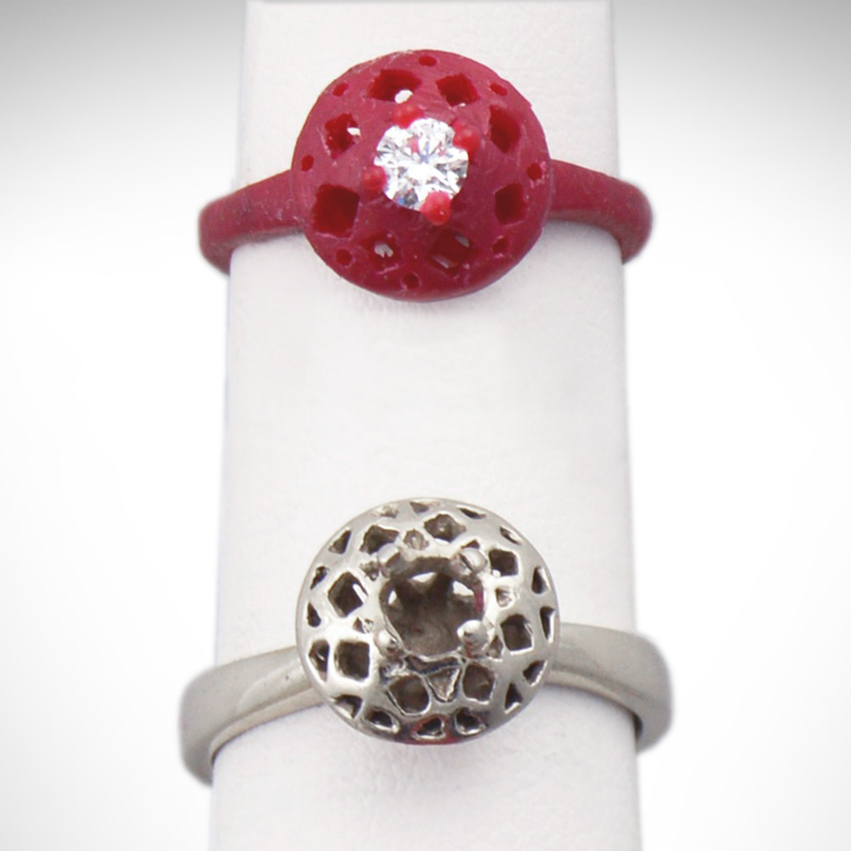 A wax model and finished white gold filigree engagement ring